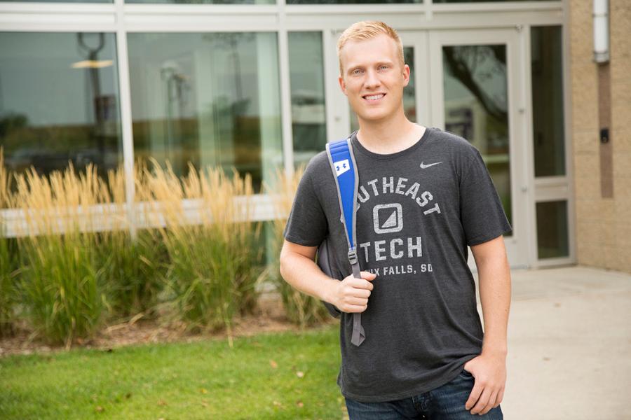 Student outdoors with backpack