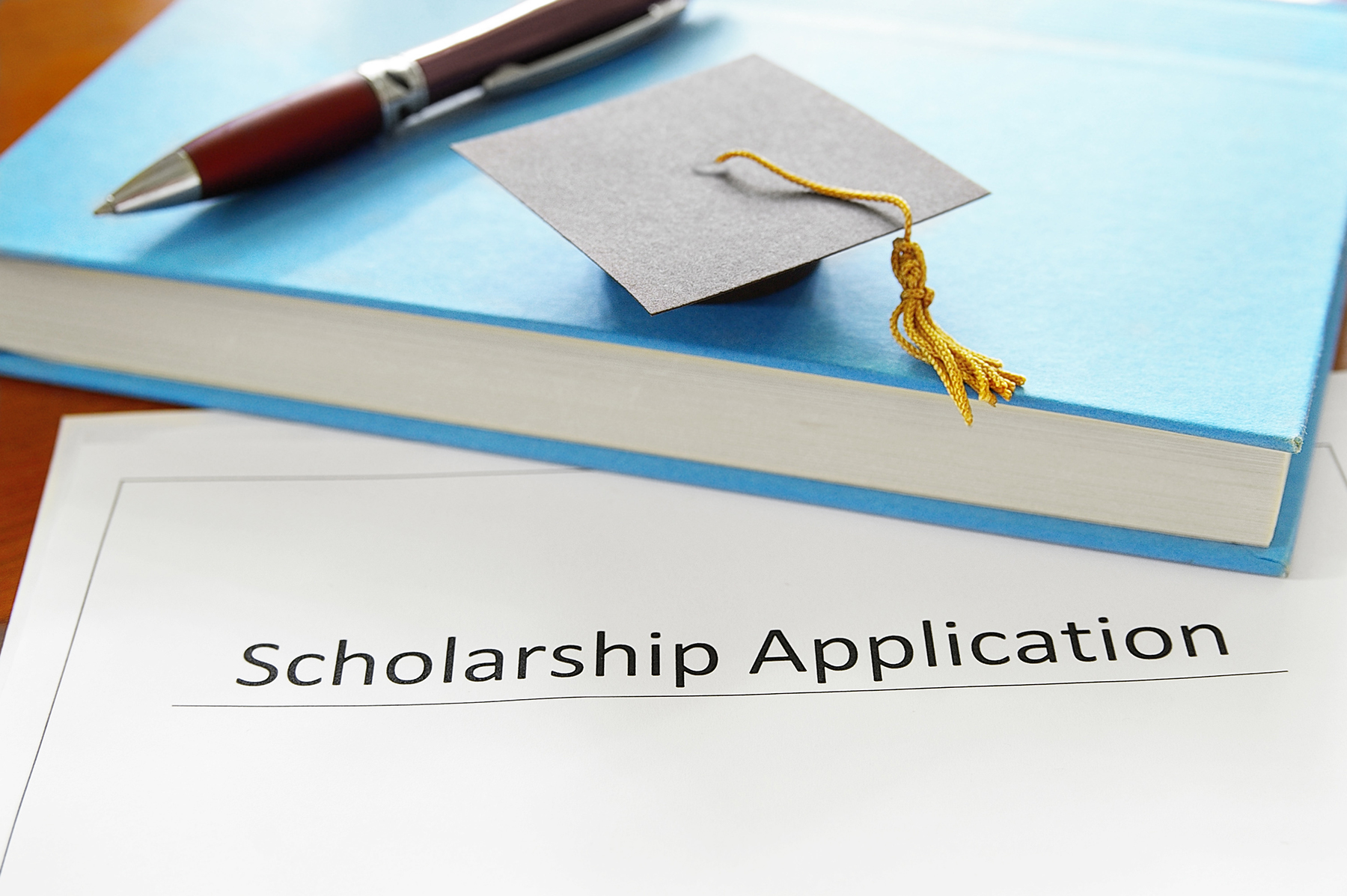 Scholarship application form next to book