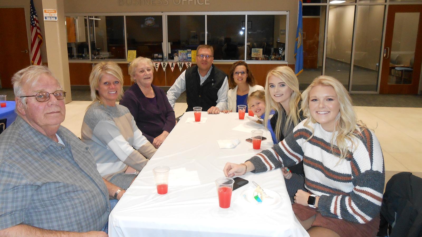 LPN student and family at reception table