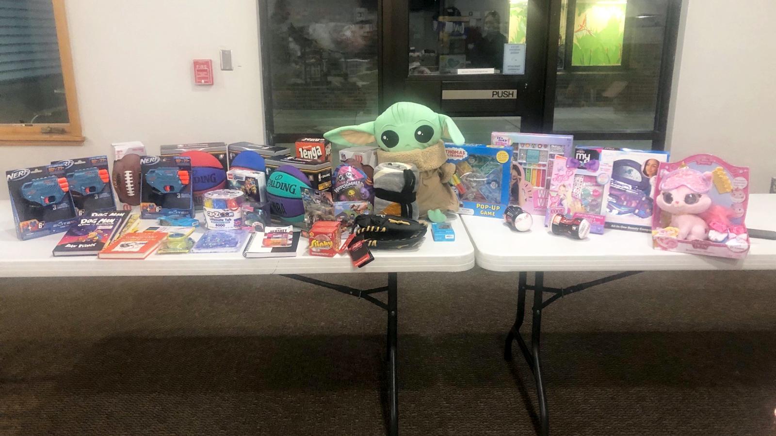 Donated toys on large white table