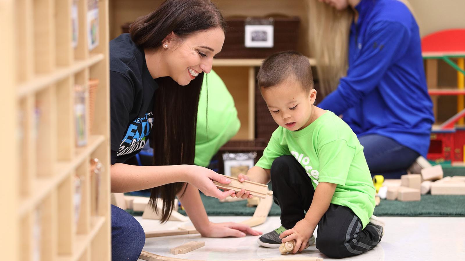 Early Childhood Student working in lab with child