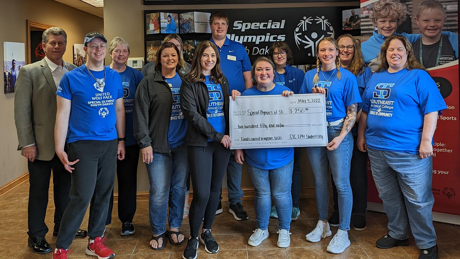 Group photo with large check