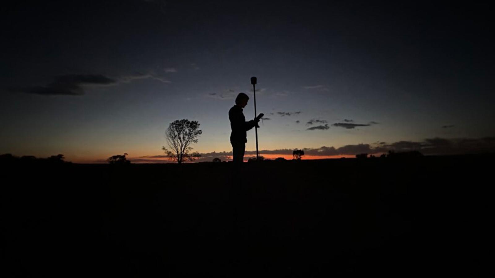 Sunset photo of Kayden Kummer while performing the duties of a Civil Engineer. 