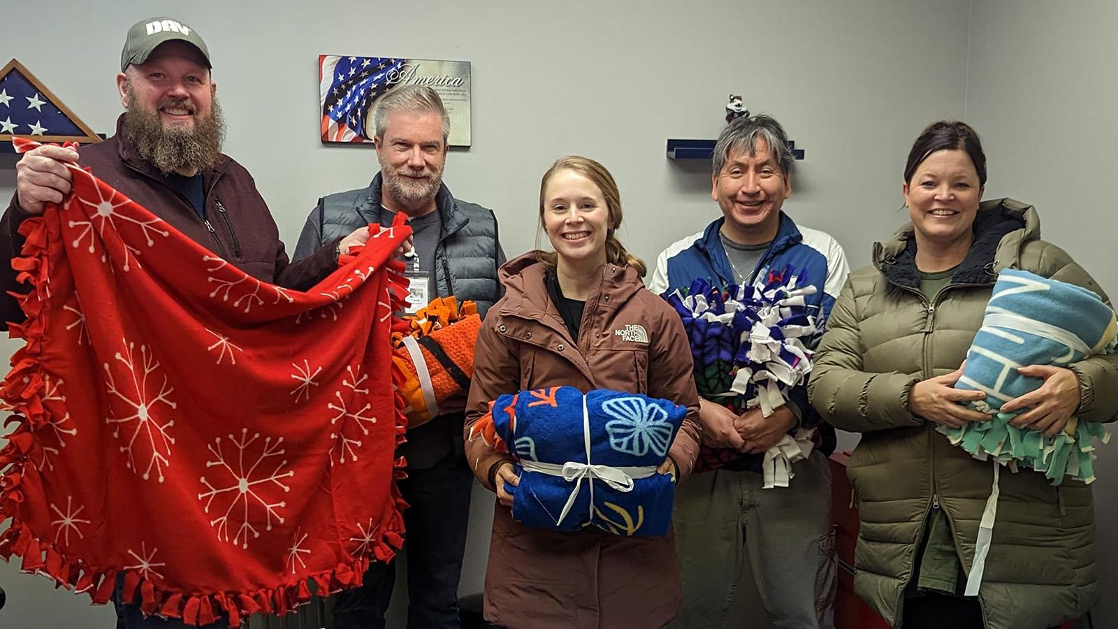 Group photo of faculty, veterans with fleece blankets