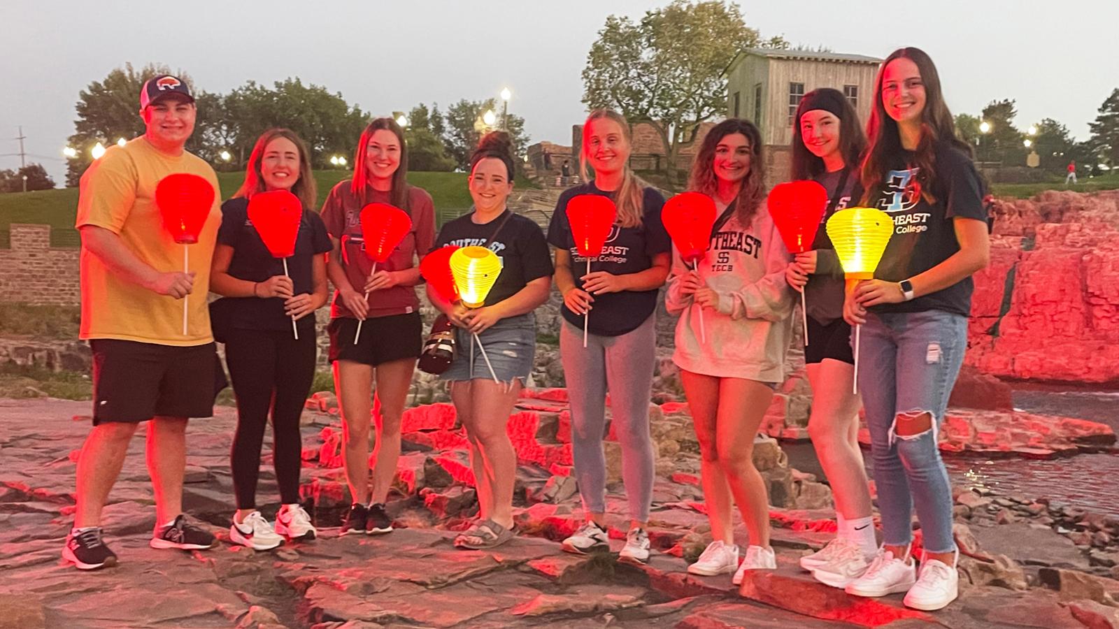 Students at Falls Park with lit lanterns