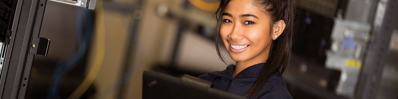 Young woman smiling in server room