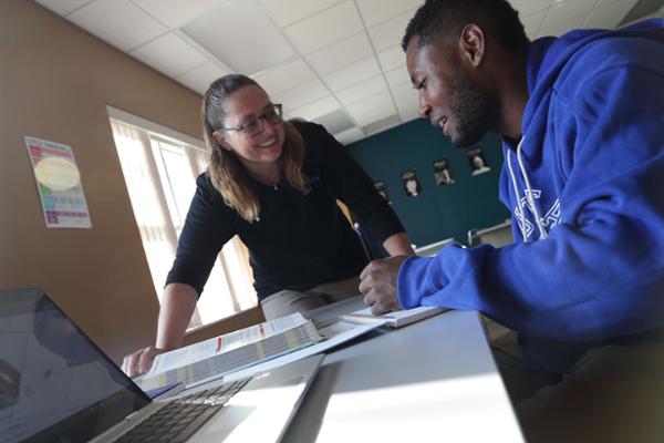 Student and instructor at study table