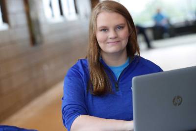 Student at study area with open laptop