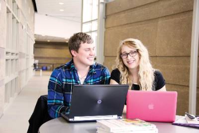 Two students with a laptop