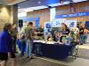 Welcome table at signing day with blue table cloth and admissions staff