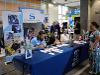 Welcome table at signing day with blue table cloth and admissions staff