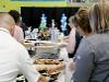 Attendees prepare plates at signing day buffet table.