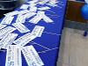 Photo prop signs with program names on a blue table. 