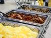 Buffet with eggs, bacon and sausage in catering pans at signing day