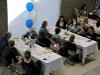 birds eye view of two tables of attendees eating breakfast