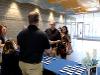 Welcome table at signing day with blue table cloth and admissions staff, facing front doors