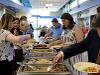 Attendees prepare plates at lunch buffet at signing day