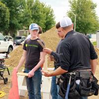 Students looking at directions on construction site.