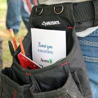 tool belt with pencils, rulers and an event program inside. 