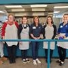 STC employees that assisted in prepping a meal stand in front of the serving window at The Banquet.