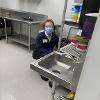 an STC volunteer near a sink at The Banquet