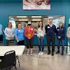 STC volunteers that volunteered to serve evening meal stand in front of serving window at The Banquet.