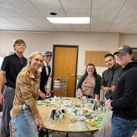 STC Volunteers at a round table displaying kits that were assembled for distribution. 