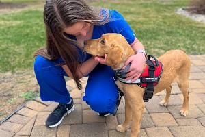 Sophie is giving Acacia petting and giving praise for doing well in training.